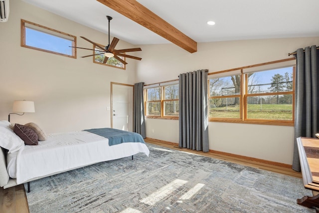 bedroom featuring baseboards, lofted ceiling with beams, multiple windows, and wood finished floors
