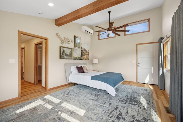 bedroom with wood finished floors, beamed ceiling, baseboards, recessed lighting, and a wall mounted AC