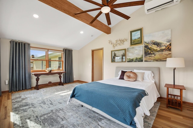 bedroom with lofted ceiling with beams, baseboards, a wall mounted AC, and wood finished floors