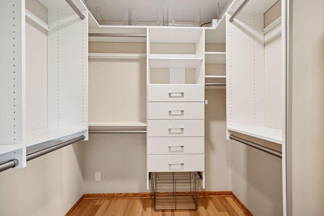 walk in closet featuring wood finished floors