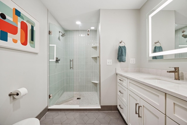 bathroom with vanity, tile patterned flooring, baseboards, recessed lighting, and a shower stall