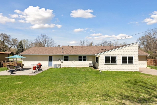 back of property with a lawn, a patio area, and fence