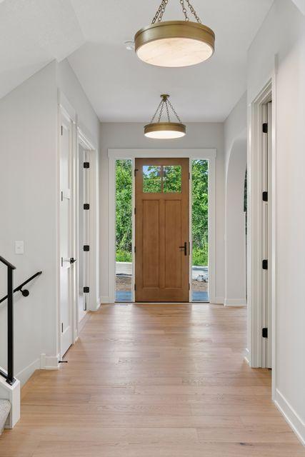 9399 Eagle Ridge Way, Chanhassen, MN 55317 - entryway featuring healthy amount of natural light, light wood finished floors, and arched walkways