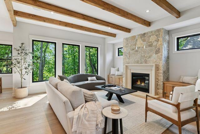 9399 Eagle Ridge Way, Chanhassen, MN 55317 - living room featuring healthy amount of natural light, beam ceiling, light wood-style flooring, a large fireplace, and recessed lighting