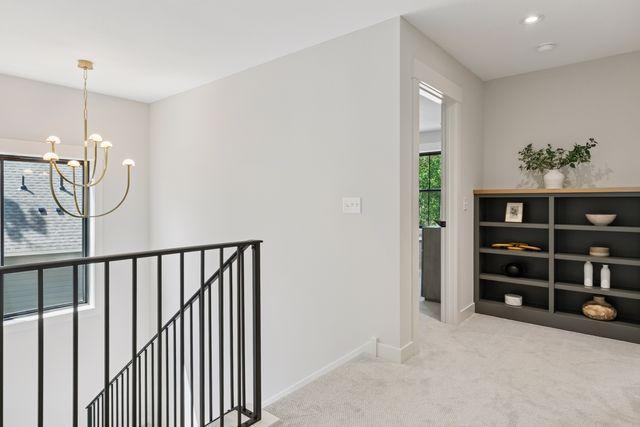 9399 Eagle Ridge Way, Chanhassen, MN 55317 - corridor with an upstairs landing, carpet, and a chandelier