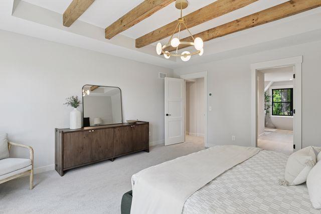 9399 Eagle Ridge Way, Chanhassen, MN 55317 - bedroom with carpet flooring, beam ceiling, a chandelier, and ensuite bath