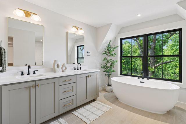 9399 Eagle Ridge Way, Chanhassen, MN 55317 - full bathroom with double vanity and a freestanding bath