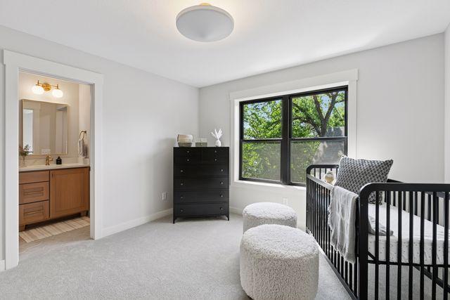 9399 Eagle Ridge Way, Chanhassen, MN 55317 - bedroom featuring light colored carpet and ensuite bath
