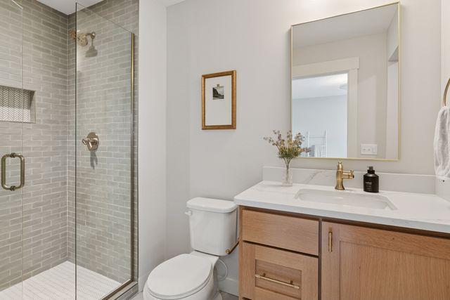 9399 Eagle Ridge Way, Chanhassen, MN 55317 - bathroom featuring vanity and a stall shower