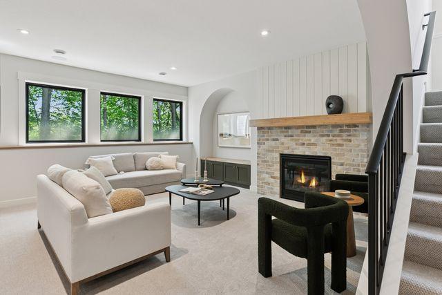 9399 Eagle Ridge Way, Chanhassen, MN 55317 - living room featuring light carpet, stairway, plenty of natural light, and recessed lighting