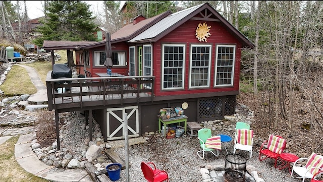 back of house with a wooden deck