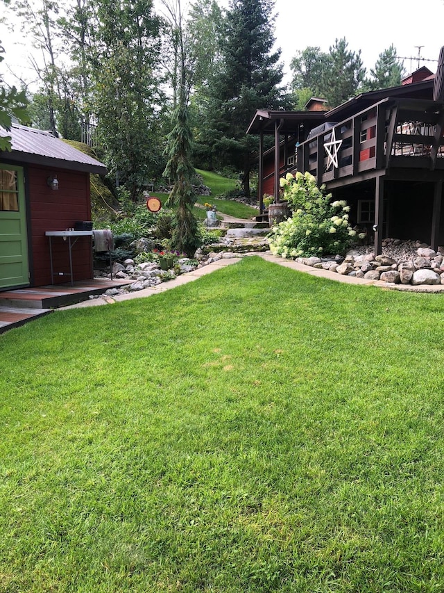 view of yard with an outbuilding and a wooden deck