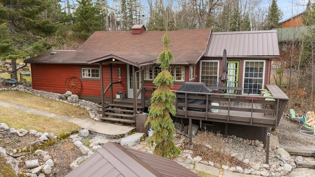 rear view of property featuring a deck