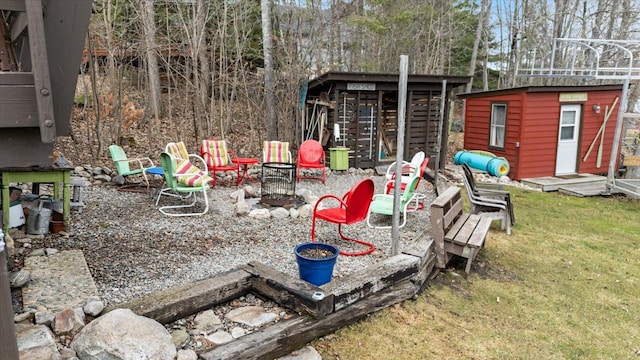 view of yard with an outdoor structure and a fire pit