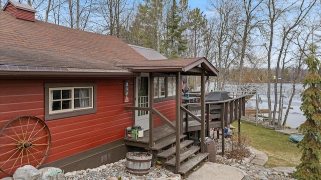 exterior space with roof with shingles and crawl space