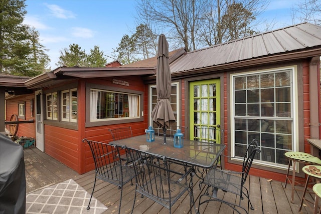 wooden terrace featuring outdoor dining space