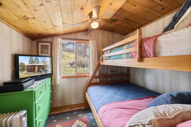 bedroom with wooden walls, wooden ceiling, carpet floors, and lofted ceiling