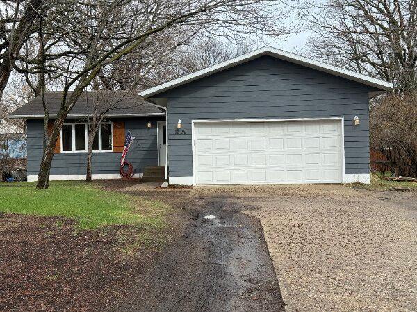 ranch-style home featuring a garage and driveway