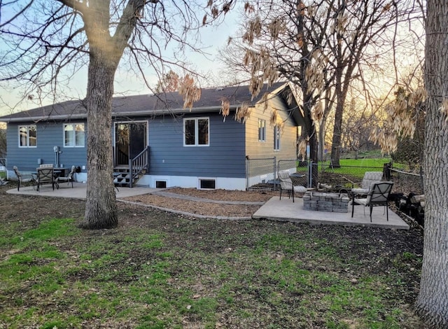 rear view of house with entry steps, a patio area, and fence