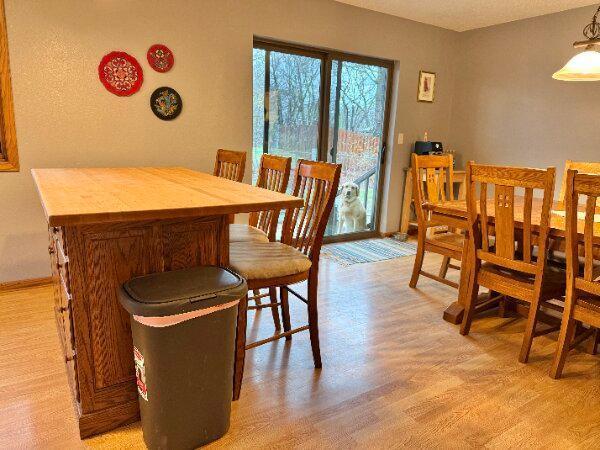 dining space with light wood-style flooring and baseboards