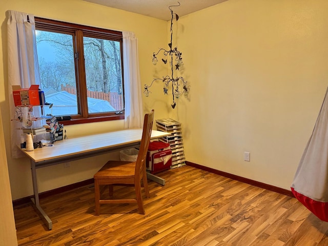 home office featuring wood finished floors and baseboards