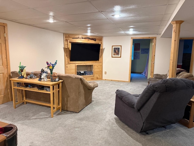 carpeted living area featuring a paneled ceiling