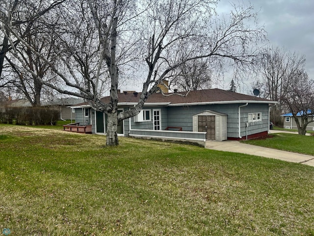 single story home with a garage, a front yard, and concrete driveway