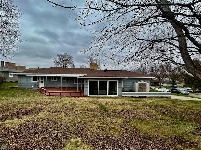 back of house with a wooden deck, a yard, and a chimney