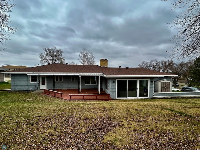 rear view of property with a yard, a patio, and a chimney