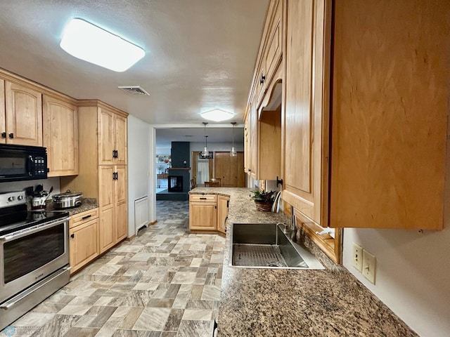 kitchen featuring light brown cabinetry, electric range, black microwave, a sink, and visible vents