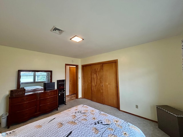 bedroom with visible vents, baseboards, a closet, and light carpet