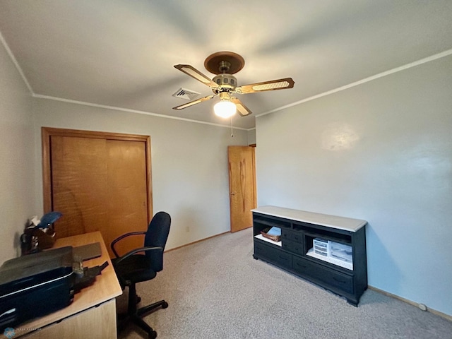 carpeted office with visible vents, a ceiling fan, baseboards, and crown molding