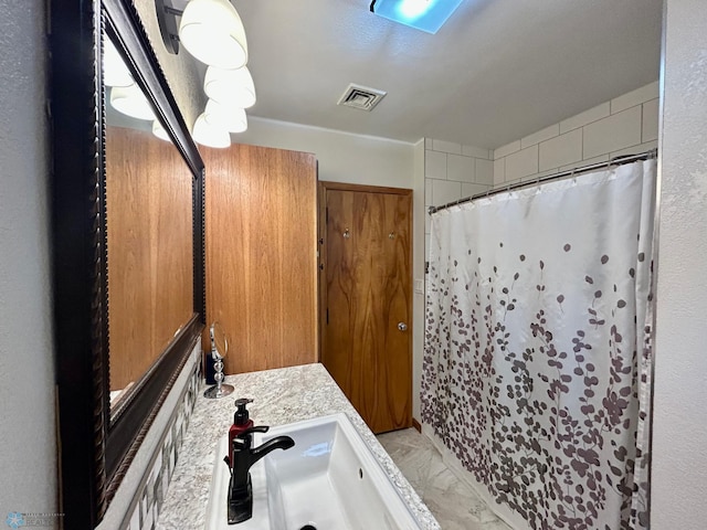 bathroom featuring a shower with curtain, visible vents, marble finish floor, and vanity