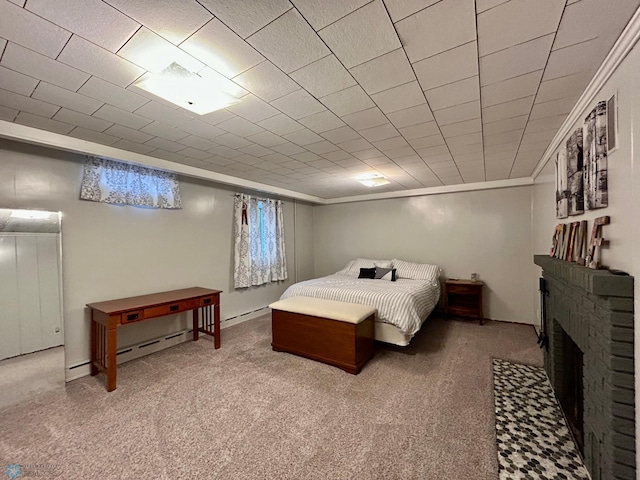 bedroom with crown molding, carpet flooring, and a brick fireplace