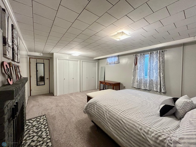 bedroom with two closets and carpet flooring
