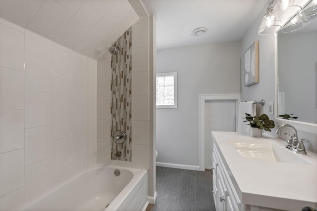 full bathroom with shower / bath combination, baseboards, and vanity