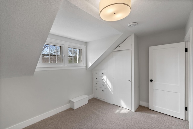 bonus room featuring carpet floors and baseboards