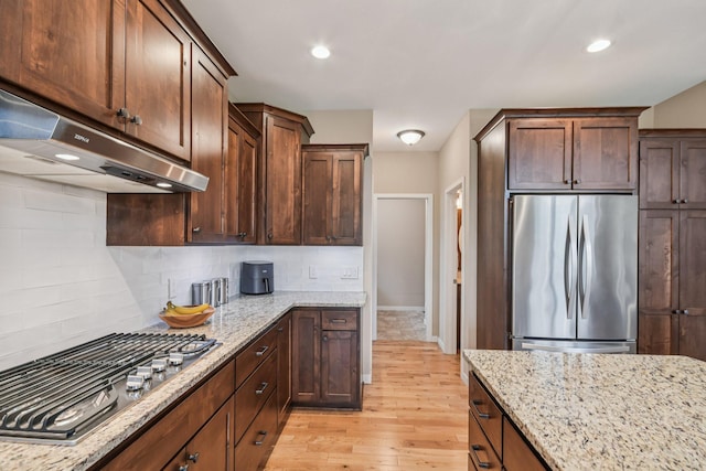 3623 Cove Point Cir NW, Prior Lake, MN 55372 - kitchen with stainless steel appliances, under cabinet range hood, light wood-type flooring, light stone countertops, and recessed lighting