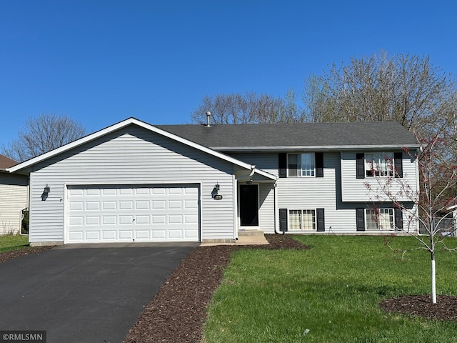 view of front of home with an attached garage, driveway, roof with shingles, and a front lawn