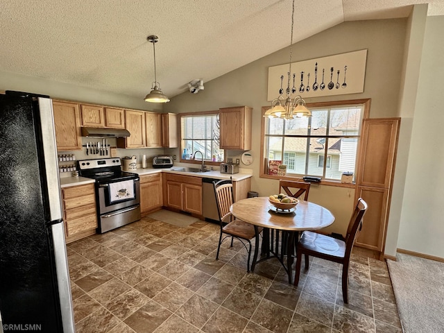 kitchen with a textured ceiling, hanging light fixtures, a sink, light countertops, and stainless steel appliances