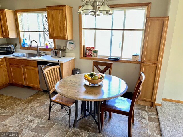 dining room featuring an inviting chandelier, stone finish floor, and a toaster