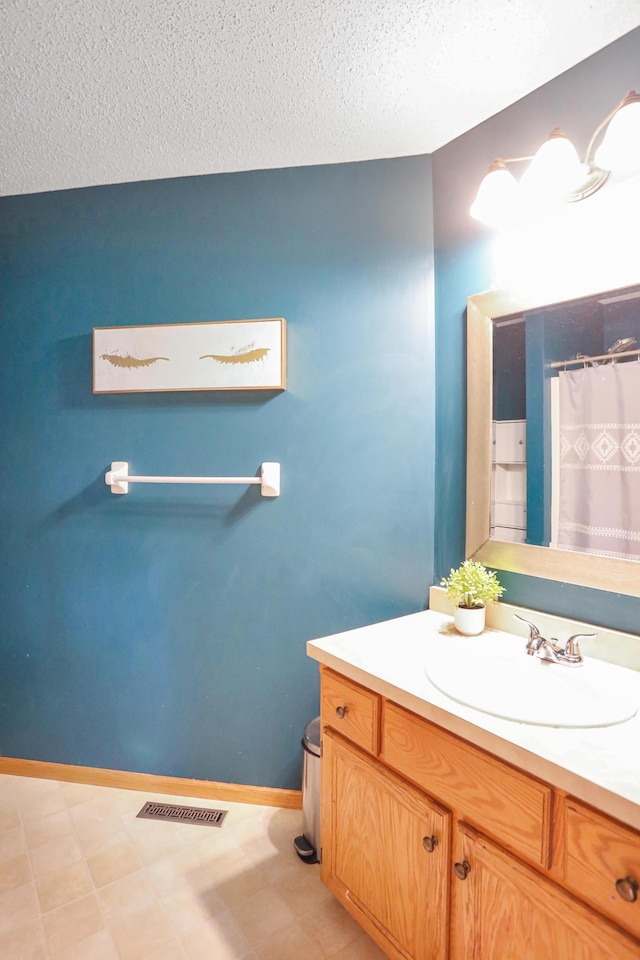 bathroom featuring a textured ceiling, visible vents, vanity, and a shower with shower curtain
