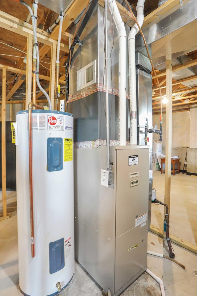 utility room with heating fuel, visible vents, and water heater