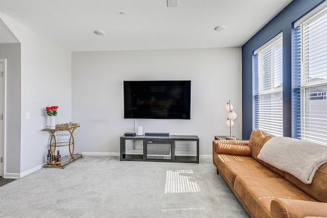 carpeted living room featuring baseboards