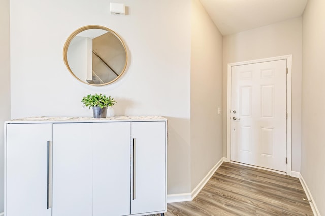 interior space featuring baseboards and light wood-type flooring
