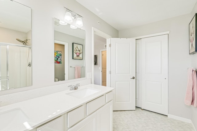 full bath featuring tile patterned floors, a shower with door, double vanity, and a sink