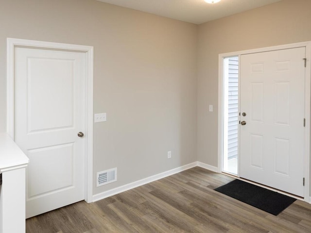 entryway with visible vents, baseboards, and wood finished floors