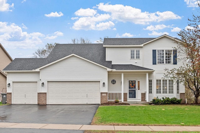 view of front facade featuring a garage, a front lawn, roof with shingles, brick siding, and driveway