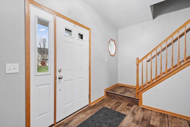 entryway with baseboards, stairs, and wood finished floors
