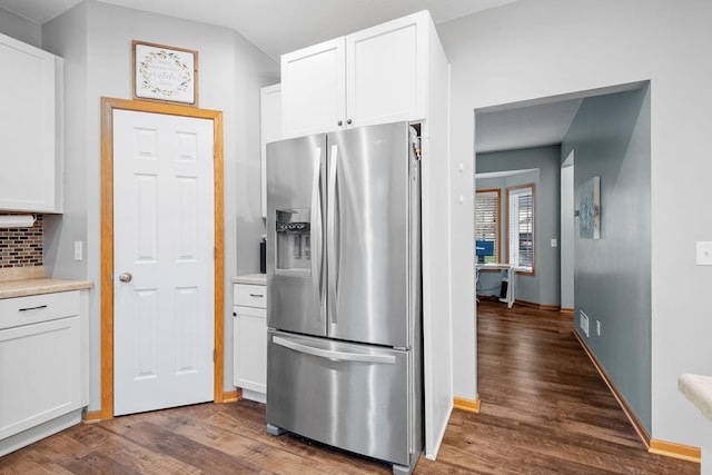 kitchen featuring decorative backsplash, wood finished floors, stainless steel refrigerator with ice dispenser, light countertops, and white cabinets